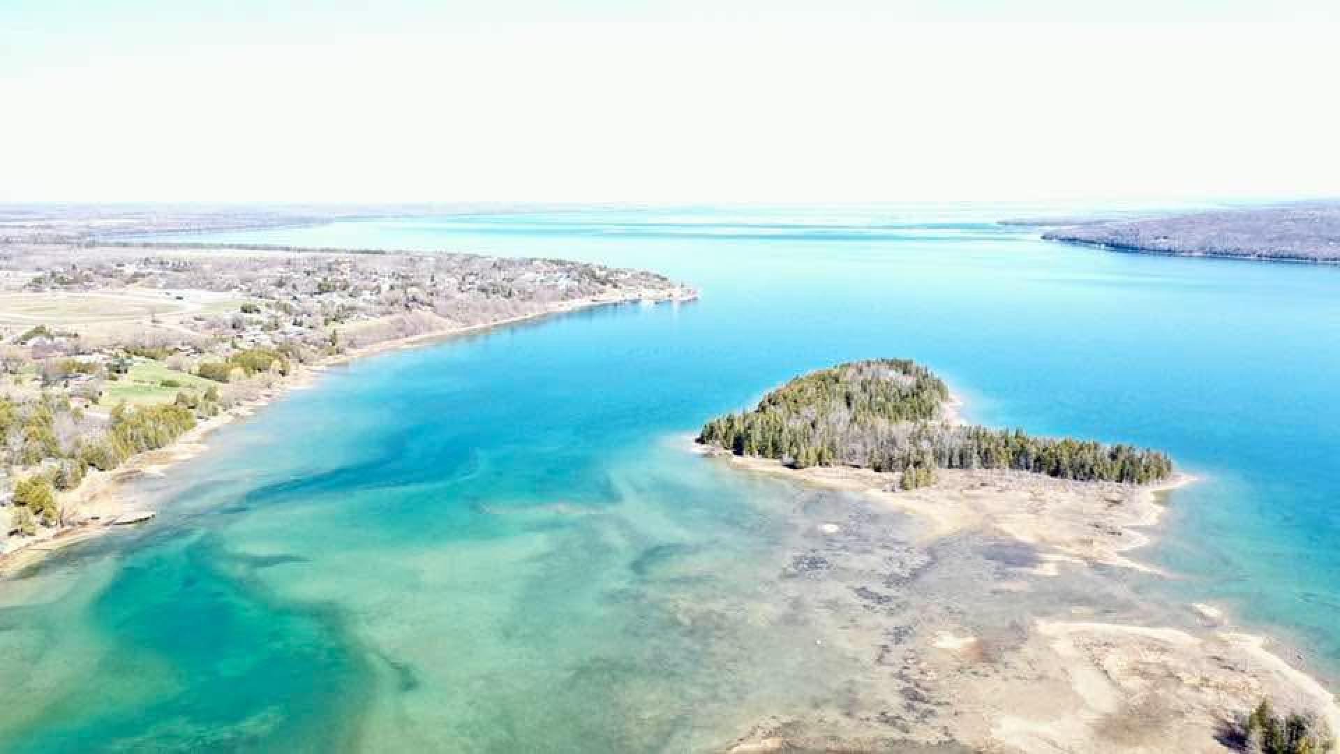 arial shot of manitowaning bay with turquoise blue water