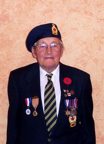 Elderly person in uniform, wearing a beret and medals, standing against an orange background.