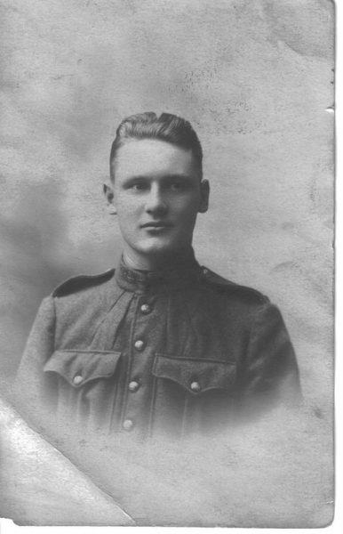 Young soldier in uniform, black and white photograph.