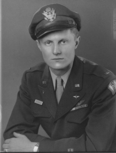 Black and white photo of a man in a military uniform and cap.