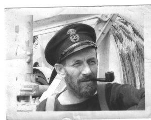 Sailor with a pipe and cap on a ship, black and white photo.