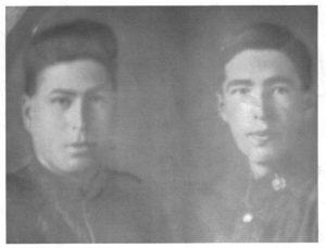Two men in uniform in a faded black-and-white photograph.