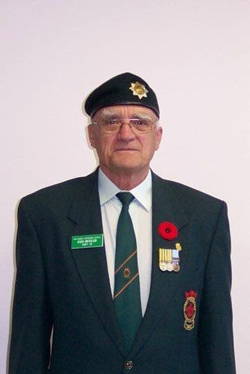 Elderly man in military uniform, wearing a beret and medals.