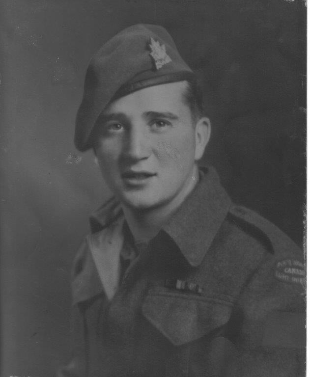 Black and white photo of a soldier in uniform and beret.