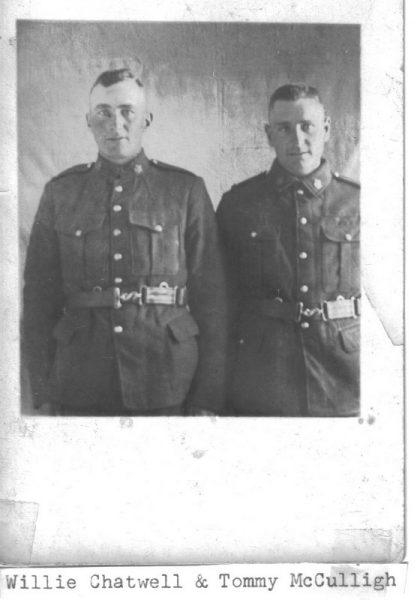 Two soldiers in uniform, standing side by side, black and white photograph.